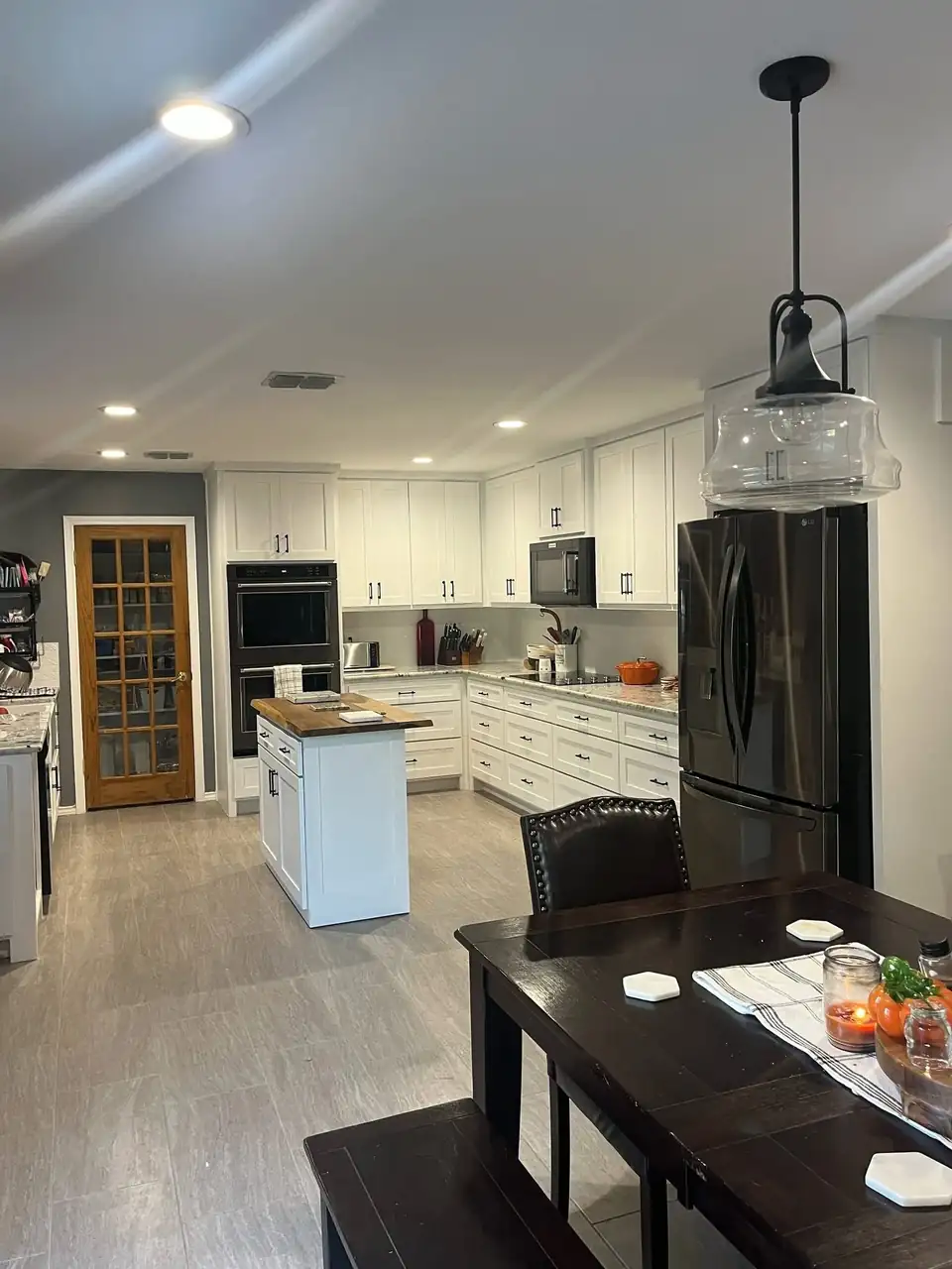 White custom kitchen cabinets with island, double wall oven and glass pendant light, custom cabinets Krum