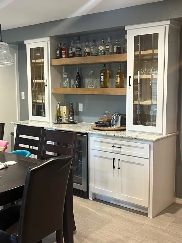 Bar area with glass-front upper cabinets, open wood shelves, granite top and wine fridge